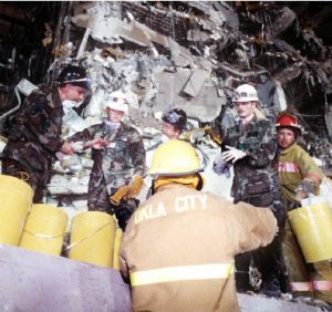 U.S. Air Force personnel work alongside civilian firefighters to remove rubble from the explosion site of the Federal Building in Oklahoma City in 1995. Anti-government extremist Timothy McVeigh carried out the bombing that killed 168 and injured 680 others. (Photo: Staff Sergeant Mark A. More)