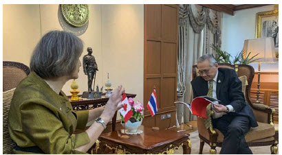 Sarah Taylor, Canada’s ambassador to Thailand, Cambodia and Laos, shares a moment and her Take Your Seat book with the deputy prime minister and minister of foreign affairs of Thailand, Don Pramudvwinai.