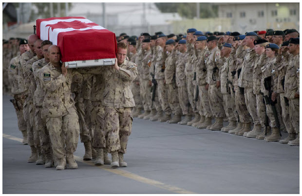 Canadians joined the U.S. war effort in Afghanistan in 2001. In all, 158 Canadian Armed Forces members lost their lives. Here, a Canadian honour guard carries the remains of Canadian army Pvt. Sebastien Courcy during a sundown ceremony at Kandahar Air Field. (Photo:  Mass Communication Specialist 1st Class Chad J. McNeeley, U.S. Navy)
