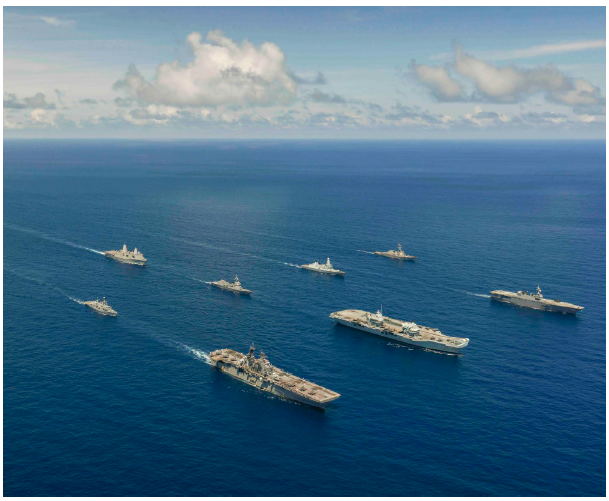 U.S. and British vessels sail in formation during a large-scale global exercise in the Philippine Sea in August 2021. A new security partnership between Australia, the United Kingdom and the U.S. will ensure such activities continue. (Photo: US DEFENSE PHOTO)