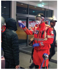 COVID will dampen our economic future 5 Public health officials administer temperature checks at an airport in Bologna, Italy. (Photo: Dipartimento Protezione Civile from Italia)