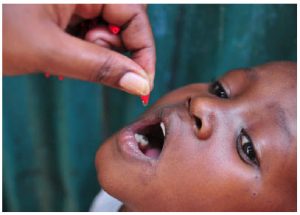 A child receives a dose of Vitamin A supplementation in Kenya. Giving malnourished children two capsules per year, up to the age of five, reduces their mortality by 24 per cent. (Photo: nutrition international)