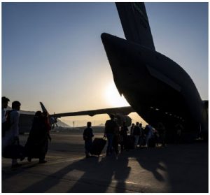 Airmen guide qualified evacuees aboard an Air Force C-17 Globemaster III while supporting the noncombatant evacuation operation in Afghanistan on Aug. 24, 2021. (Photo: ir Force Senior Airman Taylor Crul)