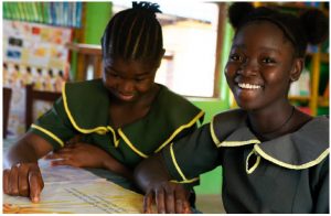 Reading Liberia books developed by CODE in partnership with local authors and illustrators feature prominently in the Girls’ Accelerated Learning Initiative, which aims to help over-age girls master literacy and numeracy skills. Without this program, girls such as Annie and Sarah, above from left, who are too old for their grade, are at high risk of never completing primary school as they contend with many social and economic barriers. (Photo: CODE/ Jefferson Krua, 2020)