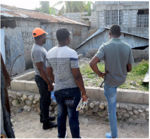 Little Footprints Big Steps staff members evaluate housing repairs. (Photo: Fransel Francois)